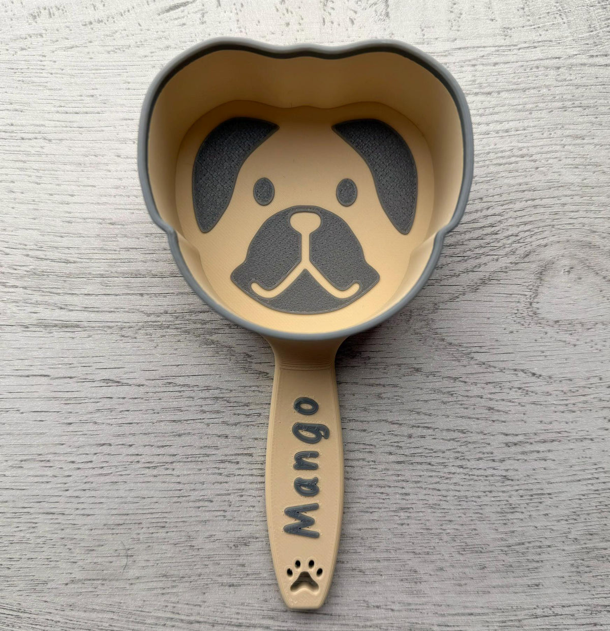 3D printed dog food scoop with a custom pet name, in a two-color finish