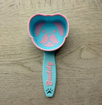3D printed dog food scoop with a custom pet name, in a two-color finish