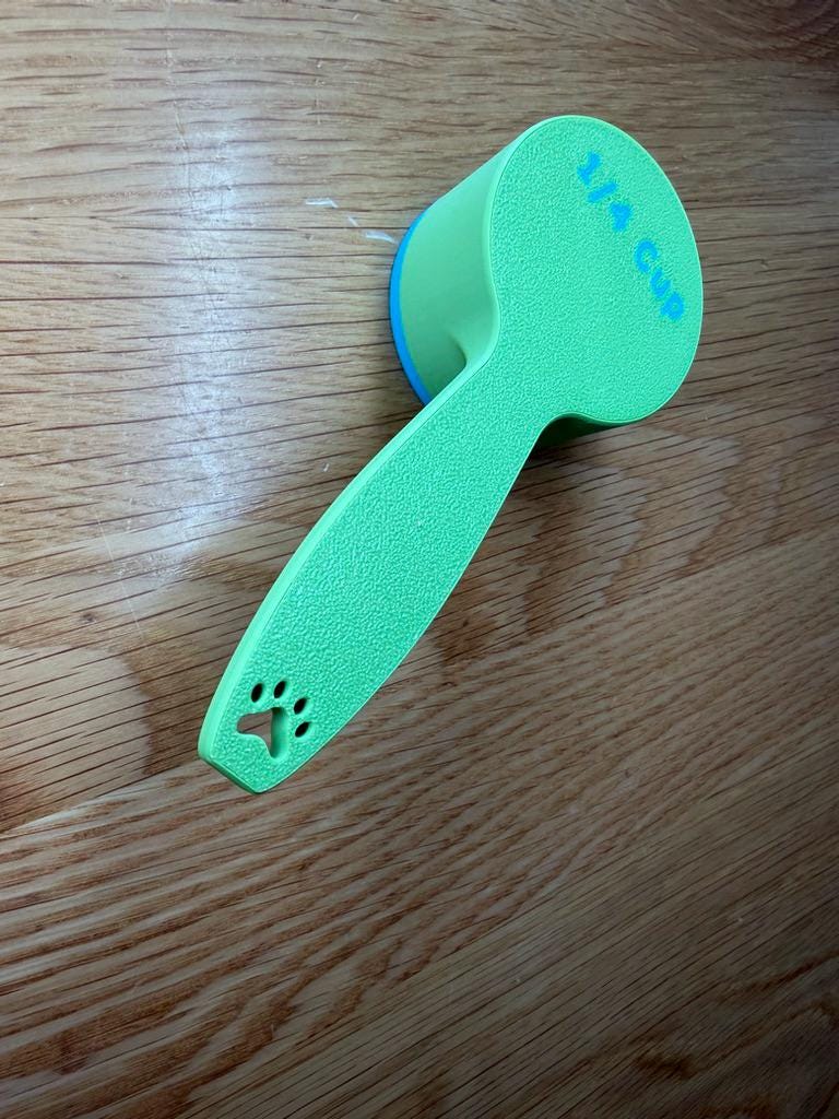 Green personalized dog food scoop showing the paw print on the handle