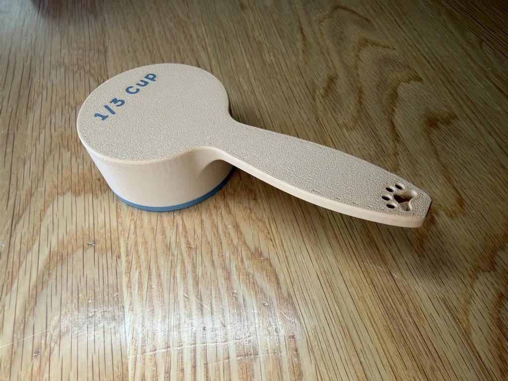 Cream dog food scoop showing the 1/3 cup size marking