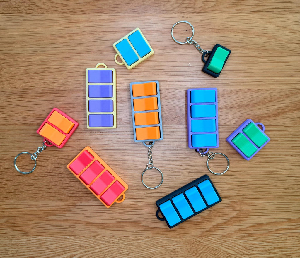 Fidget clicker keychains with real mechanical switches, sold as a three-pack