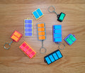 Fidget clicker keychains with real mechanical switches, sold as a three-pack
