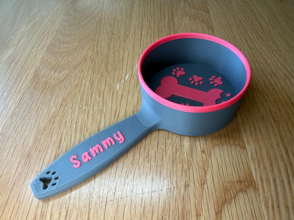 Grey and pink personalized dog food scoop printed with the name Sammy