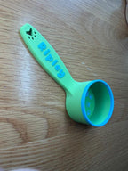 Green and blue personalized dog food scoop printed with the name Ripley