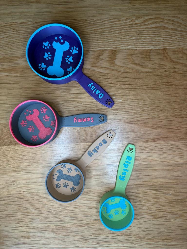 Close-up of the bone and paw design on personalized dog food scoop handles