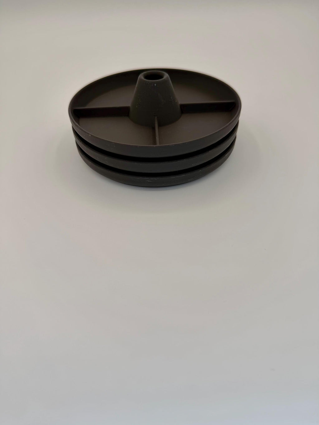 Tumbler drying rack holding a cup upside down to drain