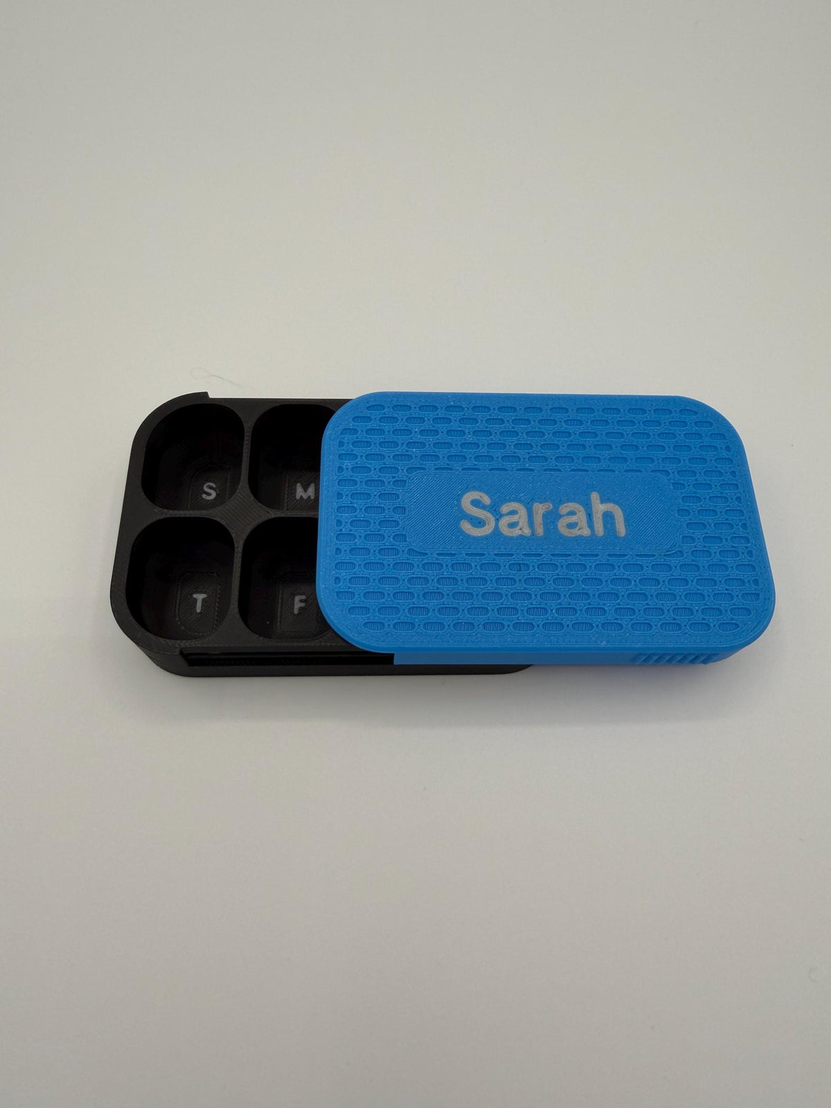 3D printed pill box with a custom name, in a two-color finish