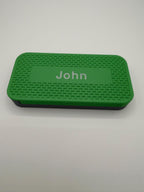 Sliding weekly pill organizer showing the compartments beneath the cover