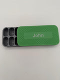 Personalized sliding pill box organizer with a custom name on the lid