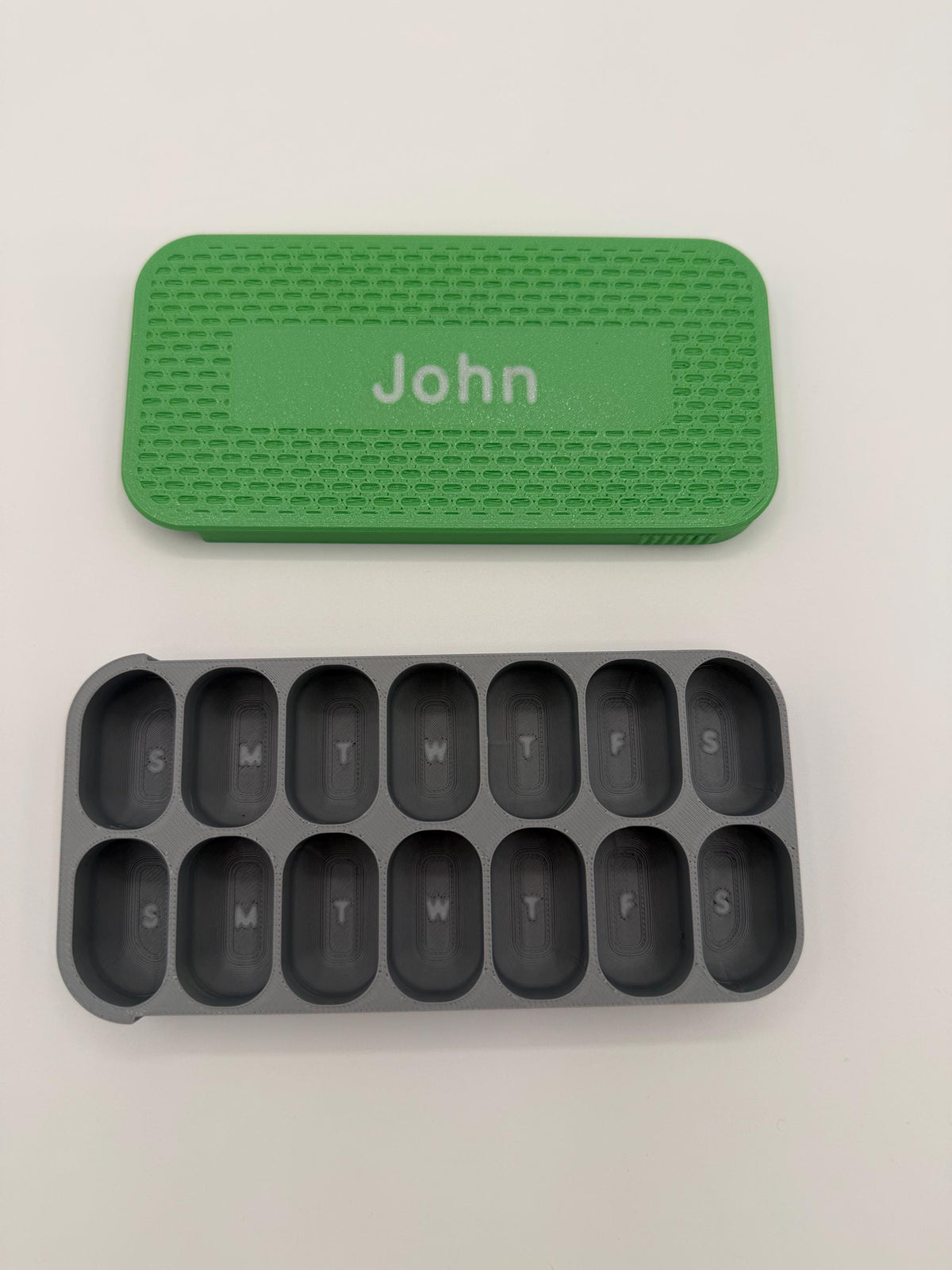 3D printed pill box with a custom name, in a two-color finish