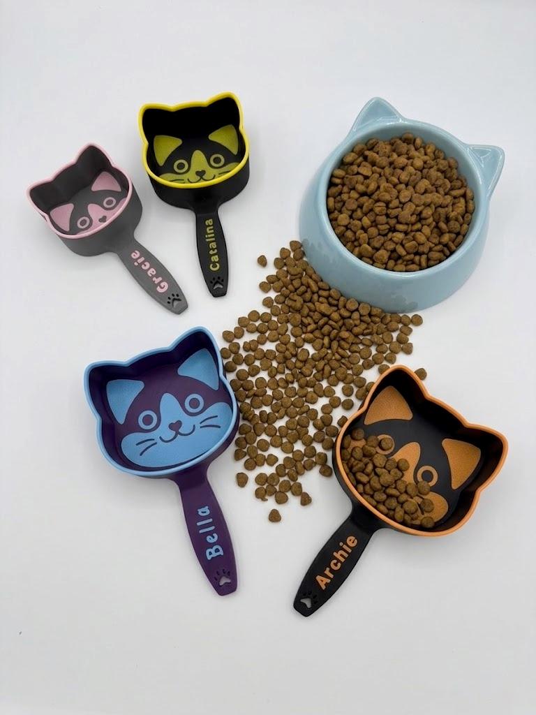 Personalized cat food scoop with a cat-face shaped cup and a custom name on the handle